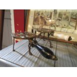 Three 19th Century and later brass trivets and an easel-back stand (4)