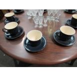 Twelve Denby style cups and saucers