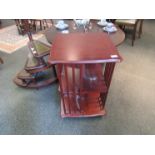 A reproduction mahogany revolving bookcase