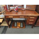 A 1930's mahogany desk with Deco styling, three drawers,