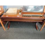 A reproduction mahogany coffee table with twin drop leaves and out-swept legs to brass feet
