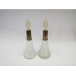 A pair of silver collared scent bottles