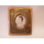An 18th Century ivory miniature portrait with details verso dating it to circa 1770 and initialled