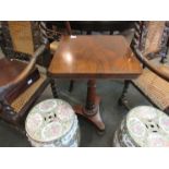 A 19th Century flame mahogany round cornered pedestal table with turned and fluted column to
