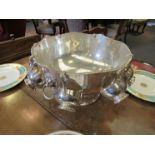 A silver plate punch bowl with lion mask detail,