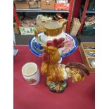 A cockerel figure, fruit bowl on pedestal, jug,