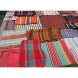 A considerable quantity of an assorted striped and checked collection to include shawls,