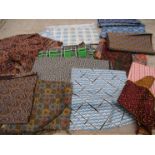 A small quantity of small scale swatches of geometric and African prints for men swear.