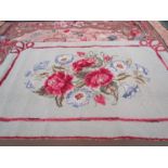 An American 1930's-40's small rosey floral hooked rug with grey, green ground,