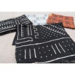 Three African mud cloths, two black and white,