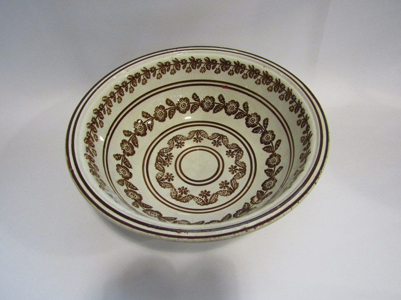 A 19th Century Irish Portneuf sponge decorated wash bowl unusually printed in brown with floral