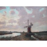 CHARLES MAYES-WIGG (1889-1969): An ornate framed oil on panel, Broads windmill at dusk.
