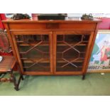 An Edwardian crossbanded and inlaid mahogany two astragal glazed door bookcase with height