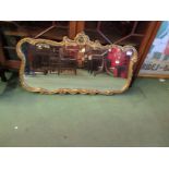 A gilt wall mirror with shaped frame,
