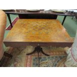 An inlaid tilt top games table on quatreform base,