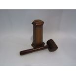A wooden money box in the form of a tower and a wooden gavel