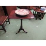 A George III flame mahogany wine table, the carved and turned column on a scroll foot tripod base,
