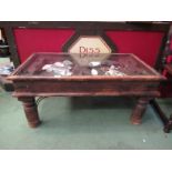 An Eastern hardwood coffee table with glass top display,