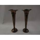A pair of silver trumpet form posy vases with frilled edges, weighted bases, stamped Birmingham,