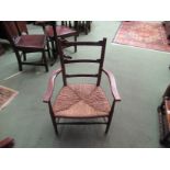 A pair of 19th Century North West Country oak and ash ladder-back elbow chairs with rush seats and
