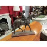 A bronzed figure of a jockey on a horse, ear a/f,