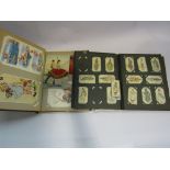 A cigarette card album and postcard album