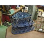 A cast iron blue three tier corner trivet