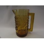 A Lalique amber coloured jug with scaled effect body, marked to base,