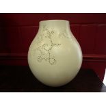 A large cream vase with impressed and pierced detail,