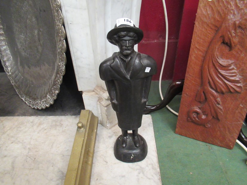 A cast figure of an artist,