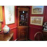 In the manner of "Maple & Co" an Edwardian inlaid mahogany full height corner cabinet,