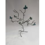 A metal jewellery tree stand decorated with birds