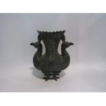 An Eastern bronze jardiniere in the form of two standing peacocks,