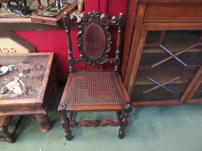 A pair of Charles II revival oak bergère chairs with carved coronet and turned decoration