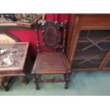 A pair of Charles II revival oak bergère chairs with carved coronet and turned decoration