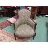A Victorian mahogany armchair with carved relief on turned and reeded tapering legs with Paisley