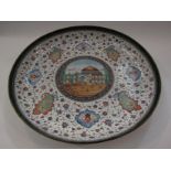 A Persian enamel dish with central image of a mosque,