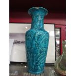 A 19th Century turquoise Persian vase decorated with flora and fauna, signed a/f,