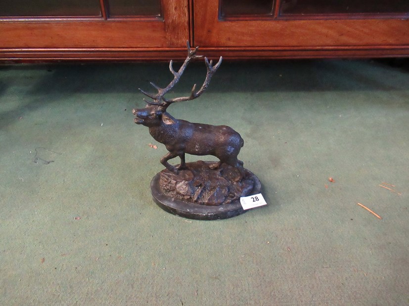 A bronzed figure of a stag on naturalistic base,