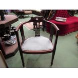 An Edwardian mahogany elbow chair the bow shape back with pierced splats having quatrefoil