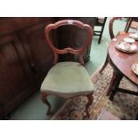 A pair of mid Victorian walnut balloon-back chairs with carved decoration on cabriole legs