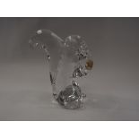 A hand blown glass squirrel with a nut