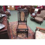 A Charles II walnut bergère chair with carved acanthus leaf and cherub decoration,