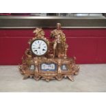 A French gilt clock with figural design and Roman numerated dial,