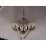 A set of five plated dressing table items with enamelled floral design