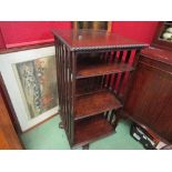 A circa 1890 oak four tier revolving bookshelf over an "X" frame base on wooden castors