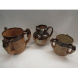 Two Doulton Lambeth tygs together with a jug with silver rim (3)