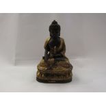 An Eastern gilt and bronze seated deity,