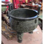 A large Chinese bronze censor on tripod feet, script to interior,