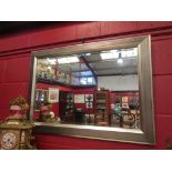 A rectangular wall mirror with bevel edge,